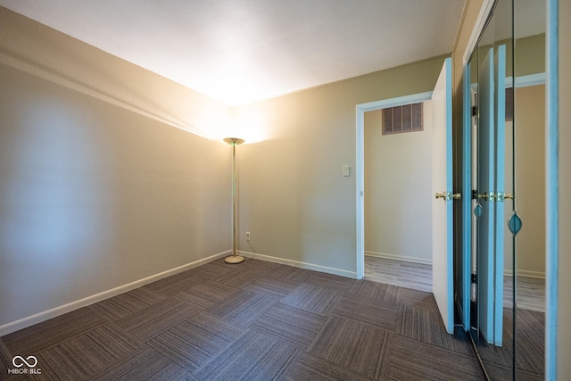 6 Heritage Dr, Terre Haute, IN 47803 - spare room featuring dark colored carpet and baseboards