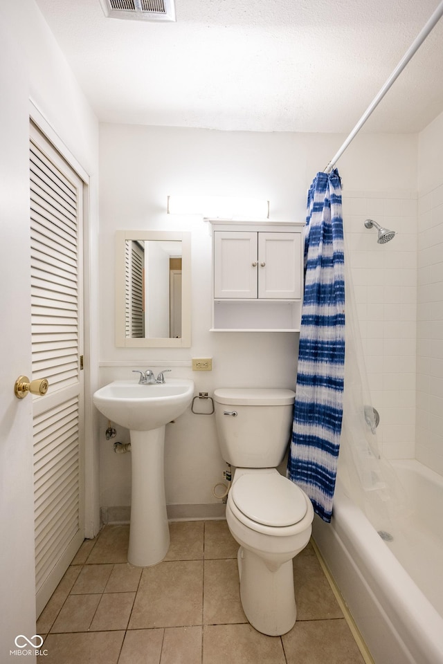 6 Heritage Dr, Terre Haute, IN 47803 - bathroom featuring toilet, shower / tub combo with curtain, tile patterned flooring, baseboards, and a sink