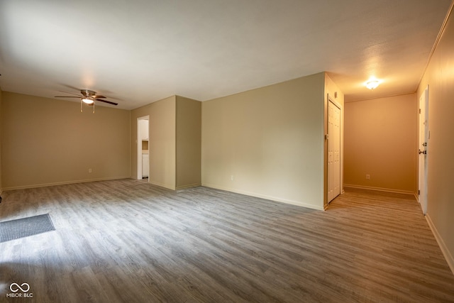 6 Heritage Dr, Terre Haute, IN 47803 - unfurnished room with wood finished floors, a ceiling fan, and baseboards