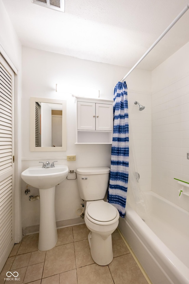 6 Heritage Dr, Terre Haute, IN 47803 - bathroom featuring toilet, shower / bath combination with curtain, tile patterned floors, a sink, and baseboards