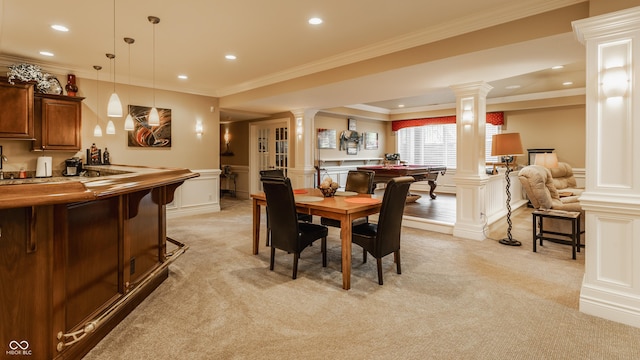 4930 Benthaven Dr E, Bargersville, IN 46106 - dining area featuring ornate columns, light carpet, bar with sink, a decorative wall, and ornamental molding