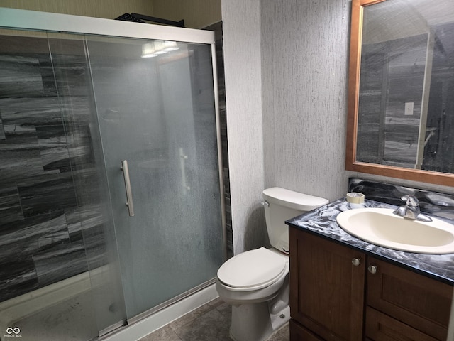 8810 Summer Walk Dr E, Indianapolis, IN 46227 - bathroom with a textured wall, a shower stall, toilet, vanity, and tile patterned flooring