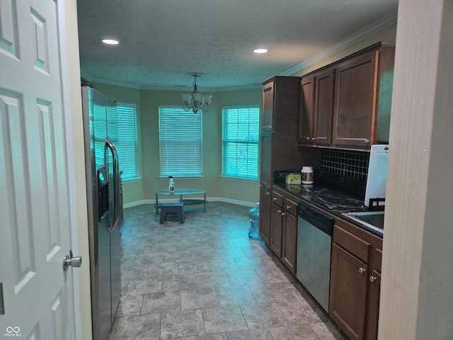 8810 Summer Walk Dr E, Indianapolis, IN 46227 - kitchen with stainless steel appliances, dark countertops, crown molding, stone finish floors, and baseboards