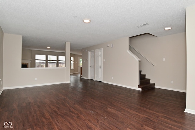 9206 Huntleigh Cir, Plainfield, IN 46168 - unfurnished living room featuring dark wood-style floors, stairway, a textured ceiling, and recessed lighting