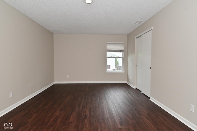 9206 Huntleigh Cir, Plainfield, IN 46168 - spare room featuring dark wood-style flooring and a textured ceiling