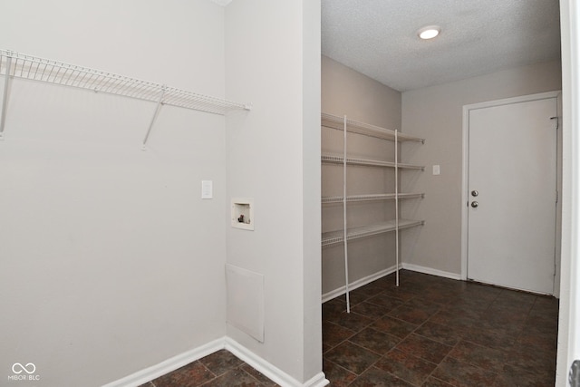 9206 Huntleigh Cir, Plainfield, IN 46168 - laundry room with hookup for a washing machine, dark stone finish flooring, and a textured ceiling