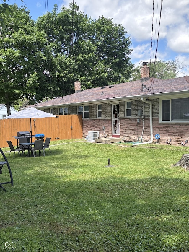 3031 W 18th St, Indianapolis, IN 46222 - rear view of property with a chimney, cooling unit, stone siding, and roof with shingles