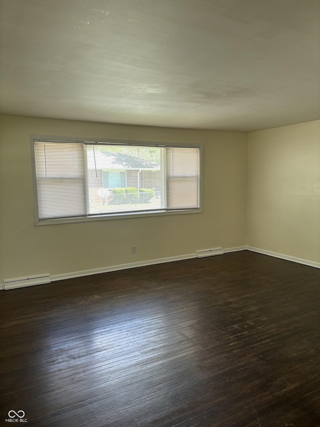 3031 W 18th St, Indianapolis, IN 46222 - spare room with dark wood-style floors, baseboard heating, and baseboards