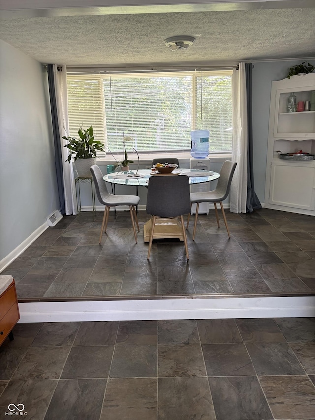 3031 W 18th St, Indianapolis, IN 46222 - dining room with a textured ceiling and baseboards