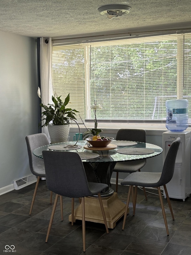3031 W 18th St, Indianapolis, IN 46222 - dining space featuring a textured ceiling and baseboards