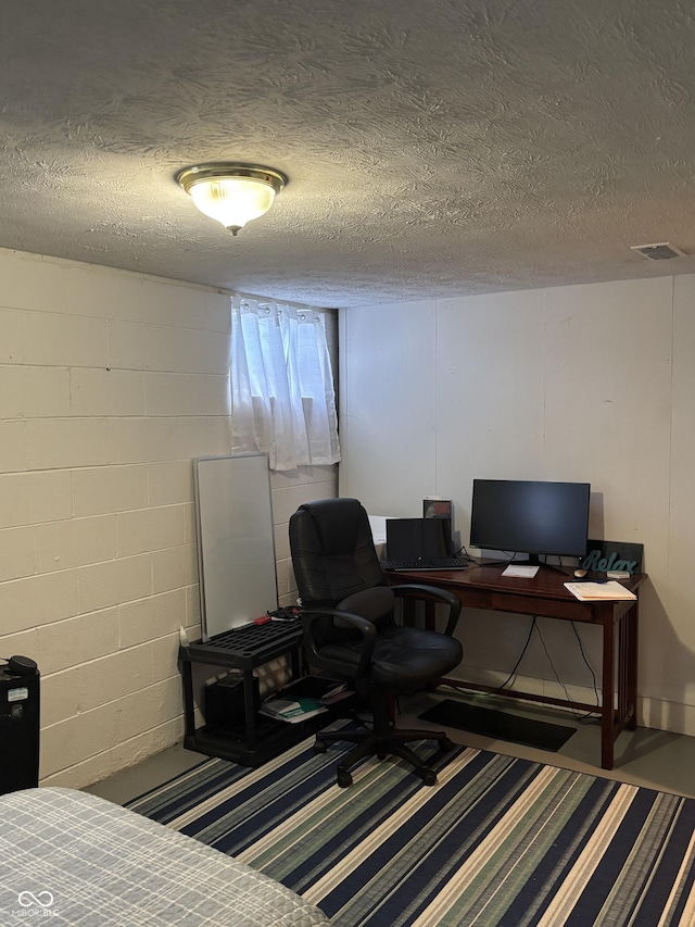 3031 W 18th St, Indianapolis, IN 46222 - bedroom with a textured ceiling, an office area, and concrete block wall