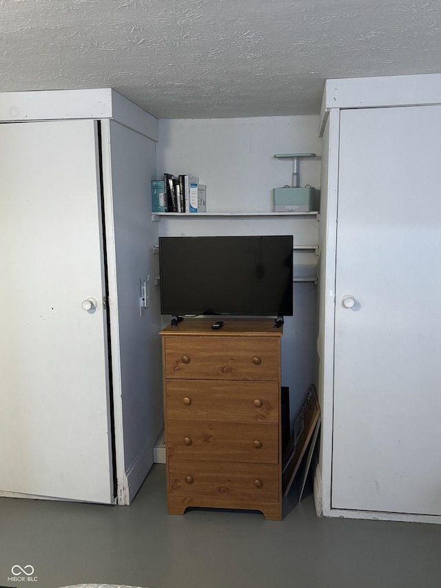 3031 W 18th St, Indianapolis, IN 46222 - bedroom with finished concrete flooring, a textured ceiling, and a closet