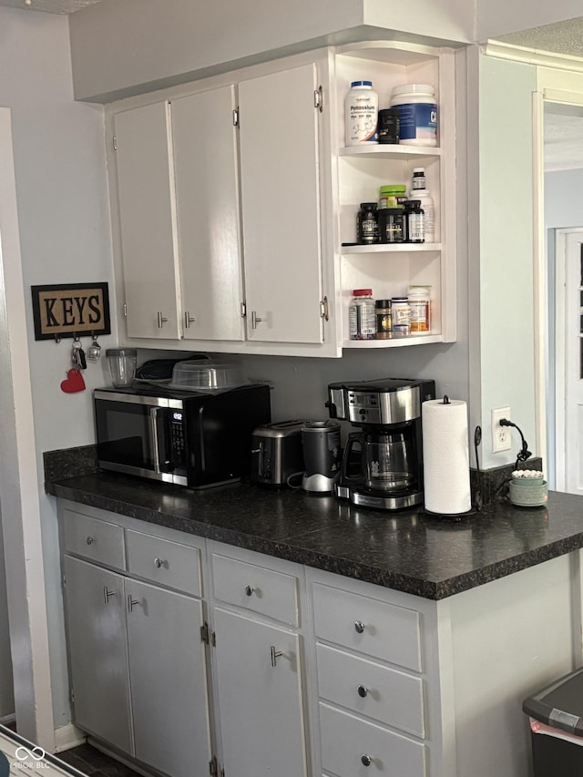 3031 W 18th St, Indianapolis, IN 46222 - kitchen with dark countertops, white cabinetry, and open shelves