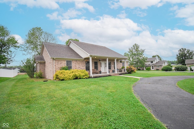 60 Bittersweet Ct, Seymour, IN 47274 - greek revival inspired property with covered porch, brick siding, a shingled roof, and asphalt driveway