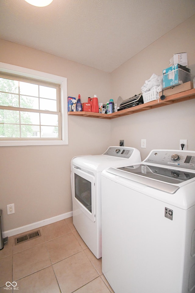 60 Bittersweet Ct, Seymour, IN 47274 - laundry room featuring washing machine and clothes dryer, baseboards, and light tile patterned floors