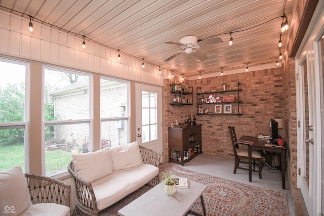 60 Bittersweet Ct, Seymour, IN 47274 - living area with track lighting, brick wall, healthy amount of natural light, and ceiling fan