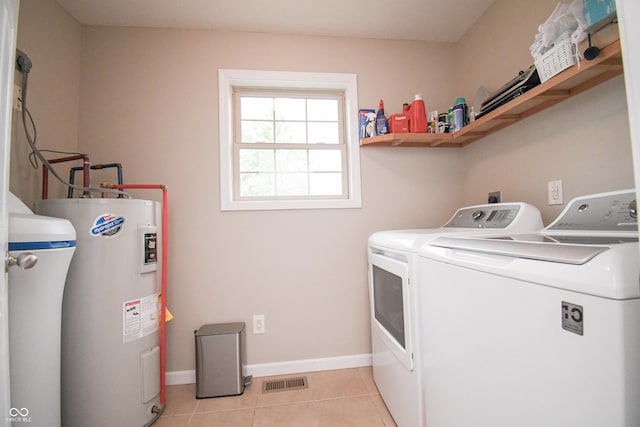 60 Bittersweet Ct, Seymour, IN 47274 - washroom featuring electric water heater, independent washer and dryer, light tile patterned floors, and baseboards