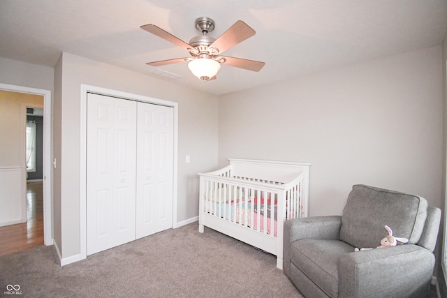 60 Bittersweet Ct, Seymour, IN 47274 - carpeted bedroom with a closet, a crib, a ceiling fan, and baseboards