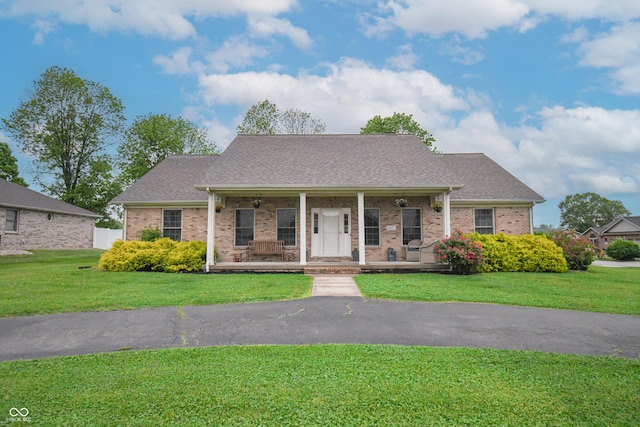 60 Bittersweet Ct, Seymour, IN 47274 - view of front of property with a porch, a front lawn, and brick siding