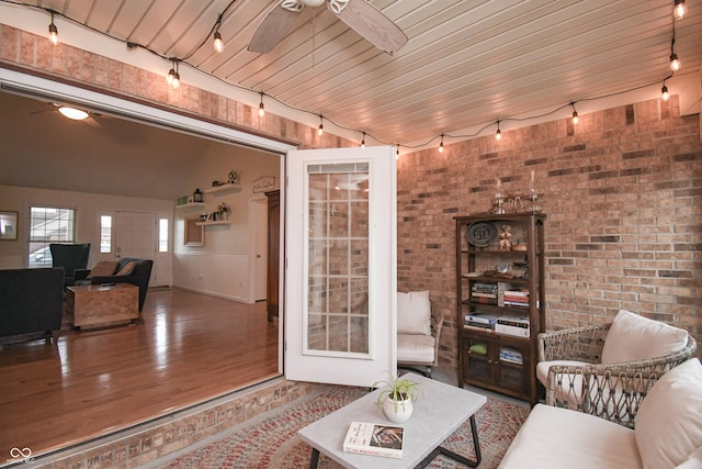 60 Bittersweet Ct, Seymour, IN 47274 - living area featuring a ceiling fan, wood finished floors, brick wall, track lighting, and lofted ceiling