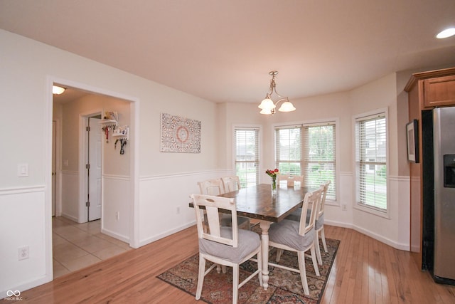 60 Bittersweet Ct, Seymour, IN 47274 - dining room with light wood-style floors, a chandelier, and baseboards