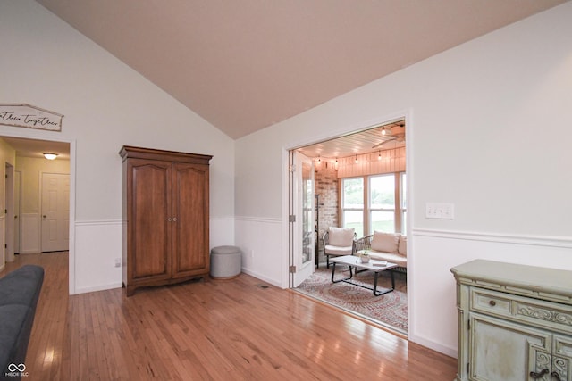 60 Bittersweet Ct, Seymour, IN 47274 - living area with light wood-style flooring, a wainscoted wall, high vaulted ceiling, and baseboards