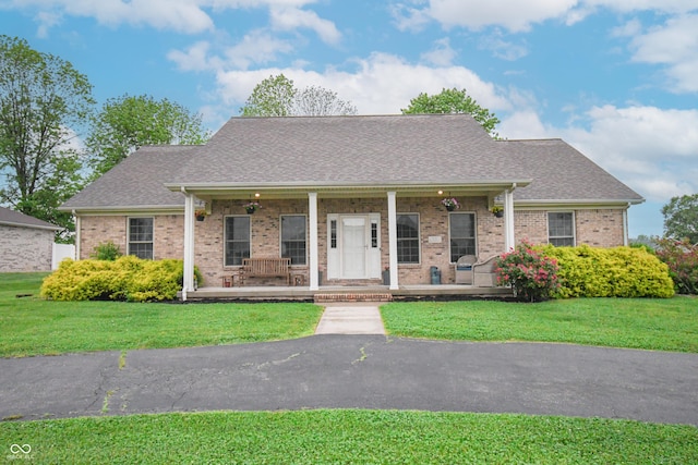 60 Bittersweet Ct, Seymour, IN 47274 - view of front of property featuring a porch, a shingled roof, brick siding, and a front lawn
