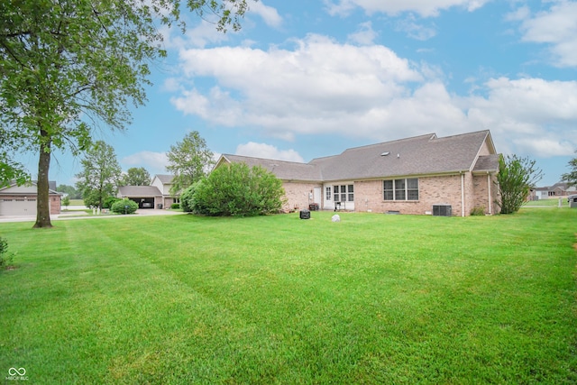 60 Bittersweet Ct, Seymour, IN 47274 - rear view of house with brick siding, a yard, and central AC