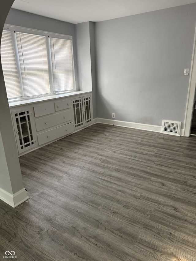 701 N Gladstone Ave, Indianapolis, IN 46201 - empty room with baseboards and dark wood finished floors