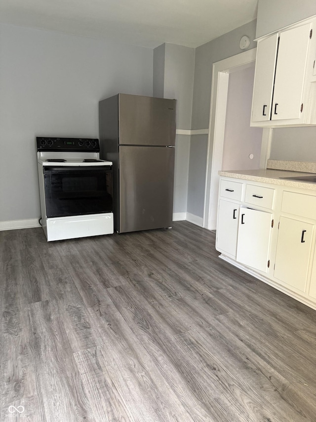 701 N Gladstone Ave, Indianapolis, IN 46201 - kitchen featuring electric stove, freestanding refrigerator, baseboards, light countertops, and wood finished floors
