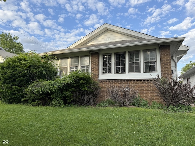 701 N Gladstone Ave, Indianapolis, IN 46201 - view of front of house featuring brick siding and a front yard