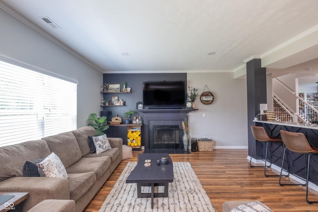 935 Northwich Ave, Westfield, IN 46074 - living area featuring stairs, wood finished floors, crown molding, a fireplace with flush hearth, and baseboards