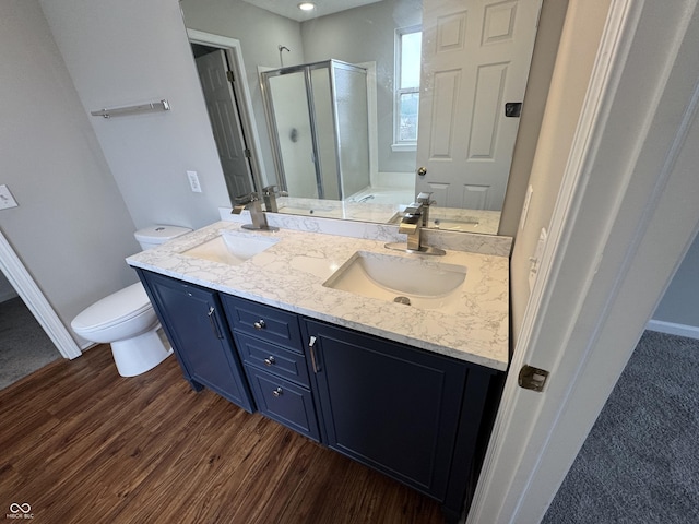 8939 Newchurch Blvd, Indianapolis, IN 46231 - bathroom featuring a shower stall, wood finished floors, double vanity, toilet, and baseboards