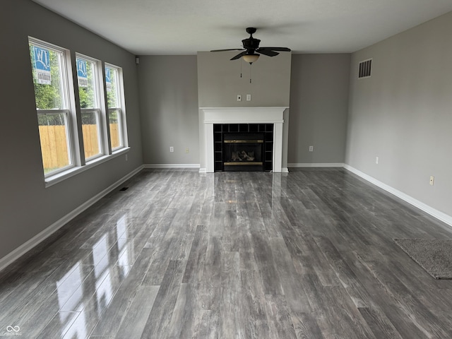 8939 Newchurch Blvd, Indianapolis, IN 46231 - unfurnished living room with a ceiling fan, dark wood-type flooring, a tile fireplace, and baseboards