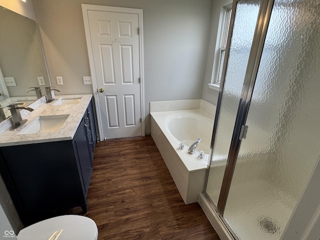 8939 Newchurch Blvd, Indianapolis, IN 46231 - bathroom featuring wood finished floors, a garden tub, a shower stall, and double vanity