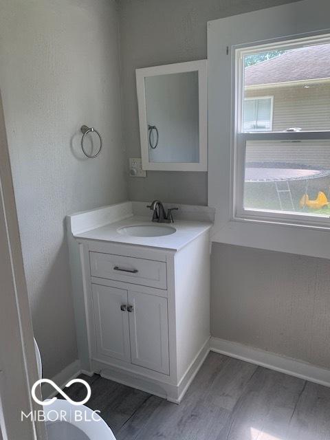 1820 S M St, Elwood, IN 46036 - bathroom with wood finished floors, vanity, and baseboards