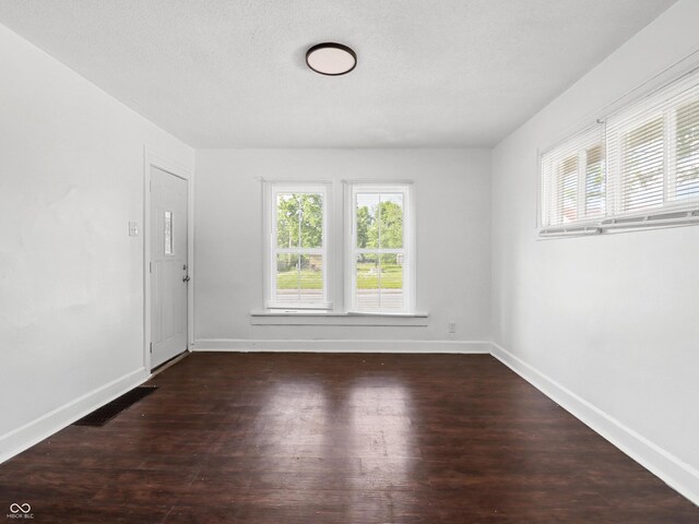 1209 W 22nd St, Anderson, IN 46016 - spare room featuring healthy amount of natural light, wood finished floors, and baseboards