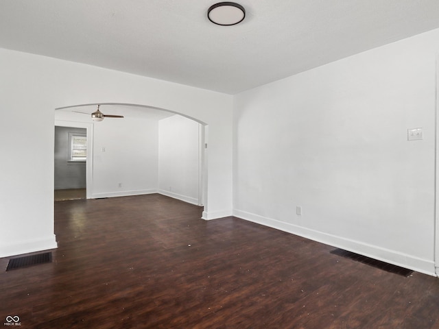 1209 W 22nd St, Anderson, IN 46016 - spare room with arched walkways, dark wood-style flooring, baseboards, and ceiling fan