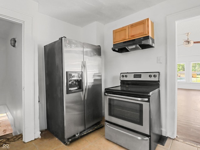 1209 W 22nd St, Anderson, IN 46016 - kitchen with appliances with stainless steel finishes, under cabinet range hood, and light tile patterned floors