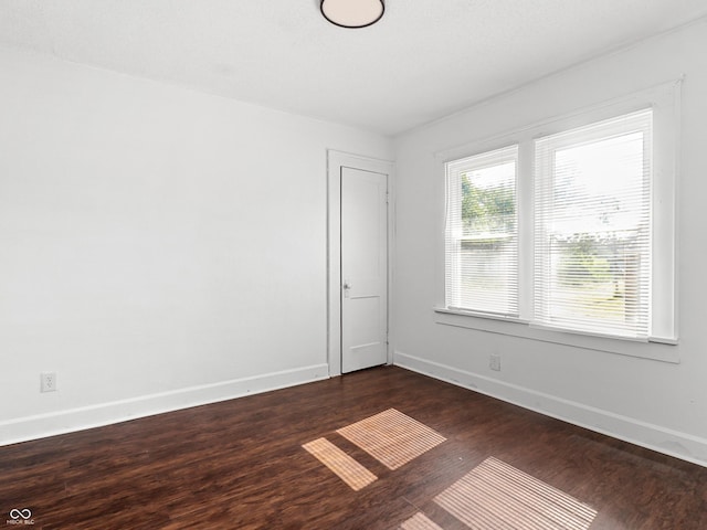 1209 W 22nd St, Anderson, IN 46016 - unfurnished room with dark wood-style floors and baseboards