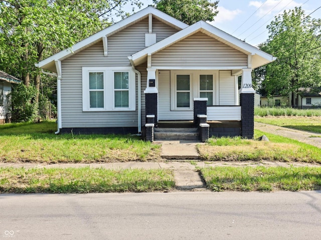 1209 W 22nd St, Anderson, IN 46016 - bungalow-style home featuring covered porch