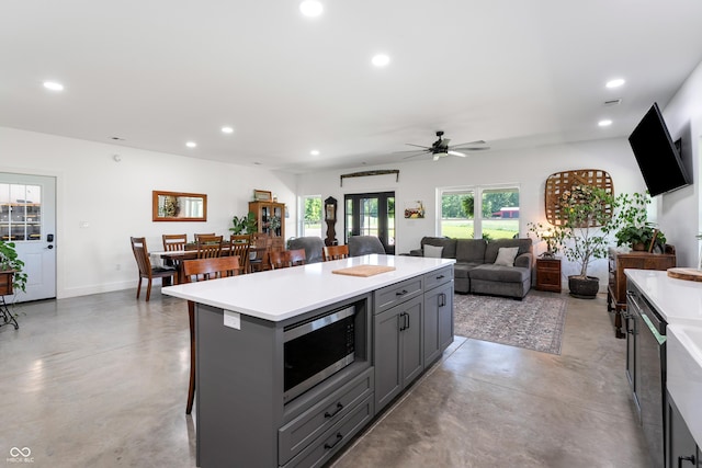 10104 E 850 S, Elizabethtown, IN 47232 - kitchen with stainless steel microwave, finished concrete flooring, recessed lighting, light countertops, and gray cabinets
