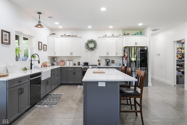 10104 E 850 S, Elizabethtown, IN 47232 - kitchen featuring stainless steel appliances, gray cabinetry, finished concrete flooring, a kitchen bar, and a kitchen island