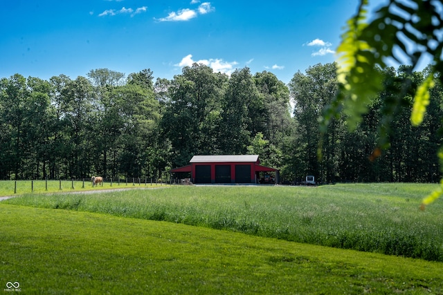 10104 E 850 S, Elizabethtown, IN 47232 - view of green lawn with a detached garage, driveway, and a view of trees