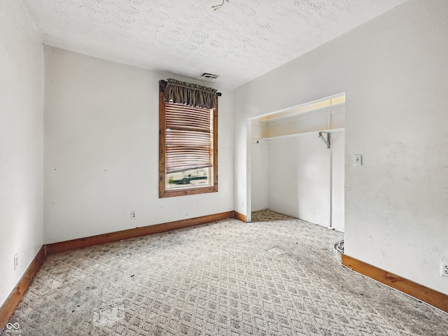 1947 N Parker Ave, Indianapolis, IN 46218 - carpeted spare room with a textured ceiling and baseboards