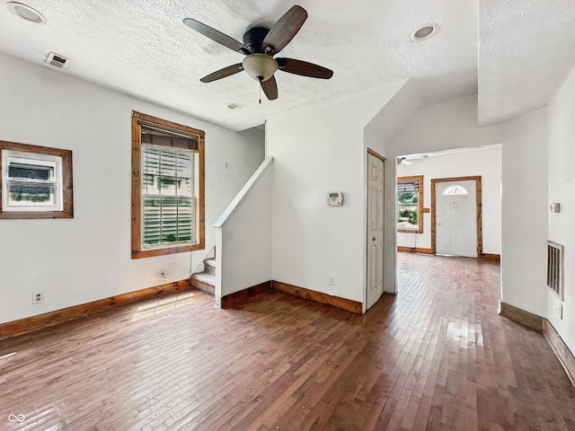 1947 N Parker Ave, Indianapolis, IN 46218 - spare room with hardwood / wood-style floors, a textured ceiling, stairway, baseboards, and ceiling fan