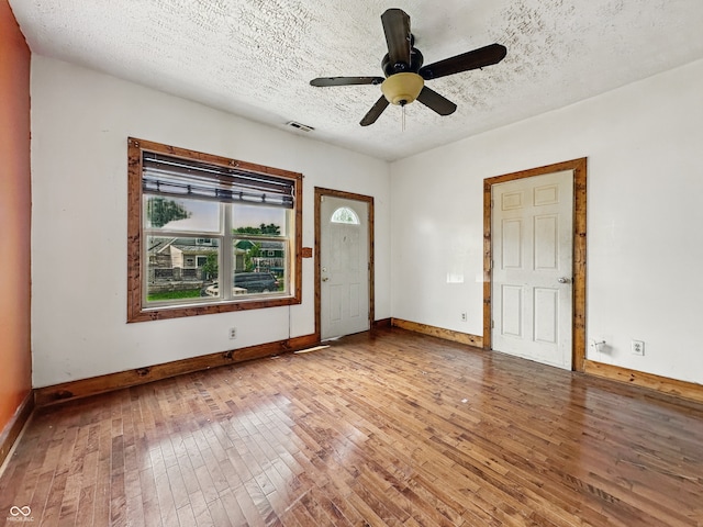 1947 N Parker Ave, Indianapolis, IN 46218 - spare room featuring light wood-type flooring, baseboards, ceiling fan, and a textured ceiling