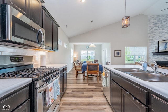 5304 Maywood Dr, Whitestown, IN 46075 - kitchen featuring stainless steel appliances, light wood-style floors, a sink, tasteful backsplash, and pendant lighting