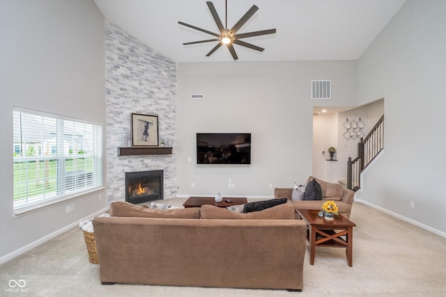 5304 Maywood Dr, Whitestown, IN 46075 - living area featuring high vaulted ceiling, ceiling fan, a fireplace, light carpet, and baseboards