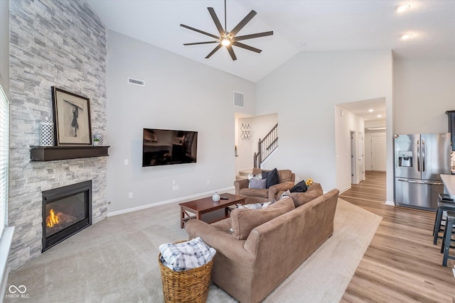 5304 Maywood Dr, Whitestown, IN 46075 - living area featuring ceiling fan, stairway, high vaulted ceiling, a fireplace, and wood finished floors